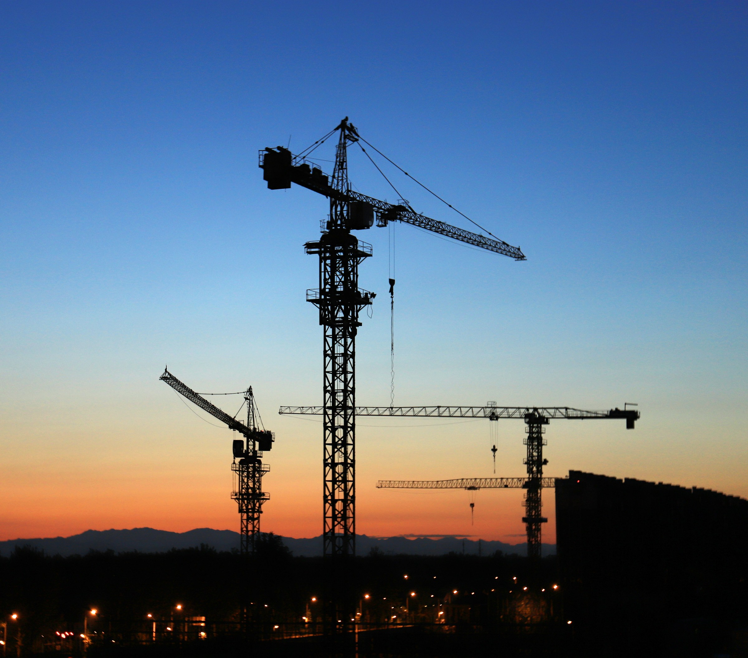 Tower cranes at golden hour