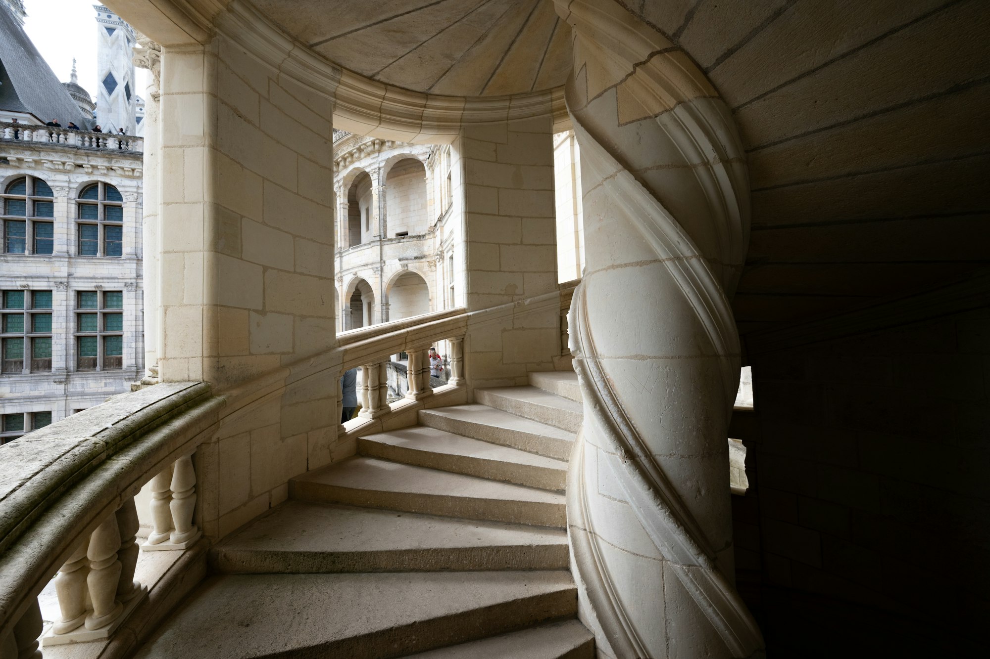 A monumental stone staircase with a stone balustrade