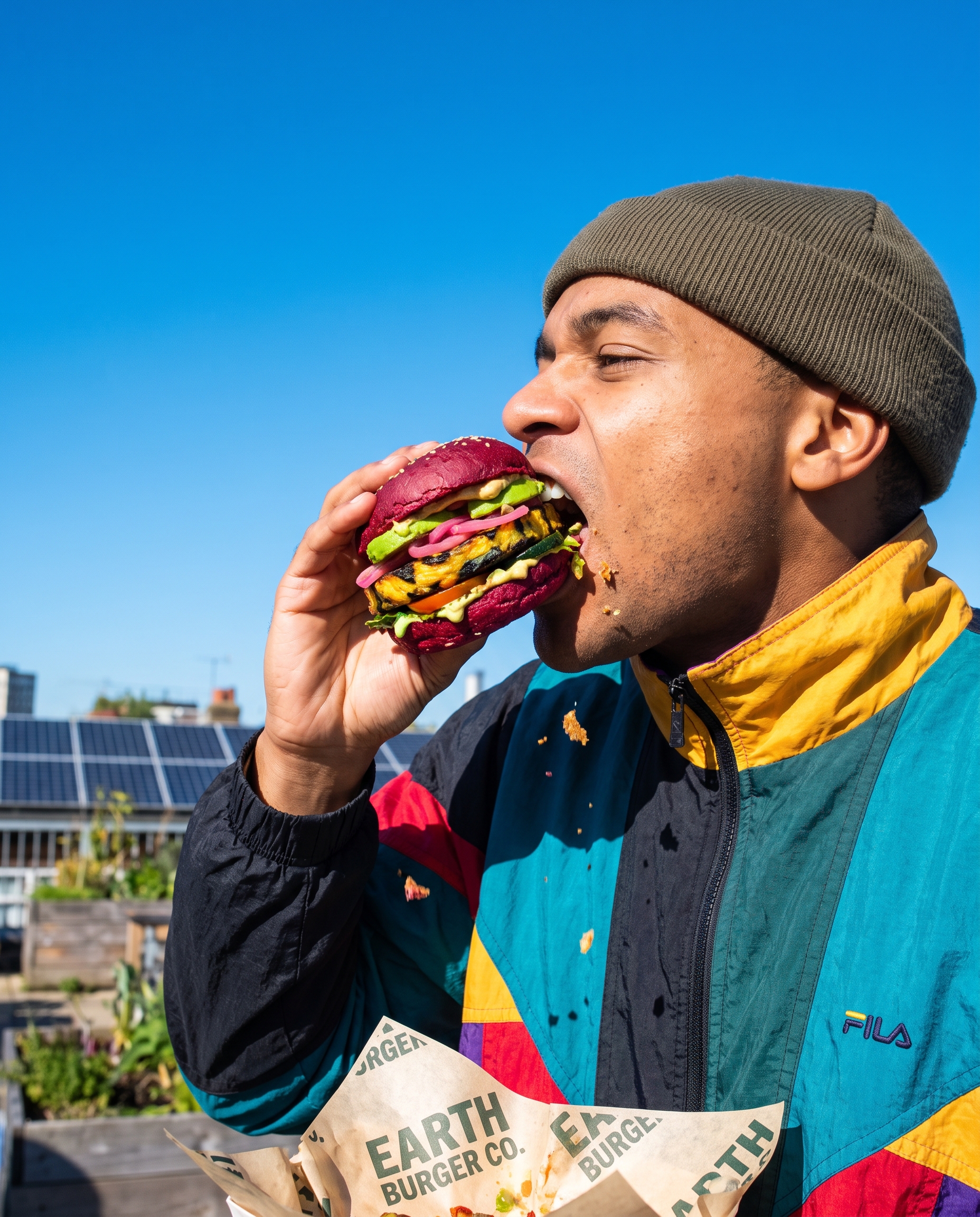 A person mid-bite with a Kernel burger